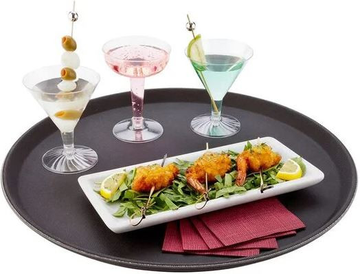 Utensils and equipment in English culinary arts: Close-up of a kitchen table setting with various utensils, plates, and glasses, including a napkin, silverware, and a water goblet.